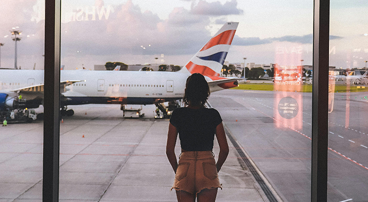 Airport hack guide: traveler breezing through airport security with suitcase and phone