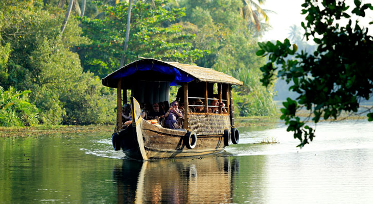 Alleppey houseboat on Vembanad Lake at sunset—iconic Kerala backwaters experience