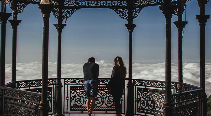 Trip buddy guide—two travelers looking at a map and planning a route
