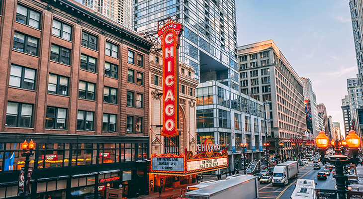 Romantic getaways in Illinois hero—couple at Chicago riverwalk at sunset with skyline