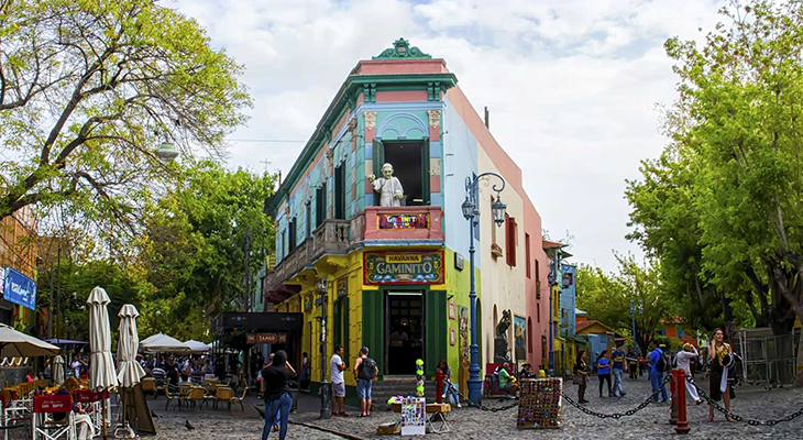 Colorful street scene in La Boca, Buenos Aires, showcasing a lively and tourist-friendly neighborhood with cafes and vibrant buildings