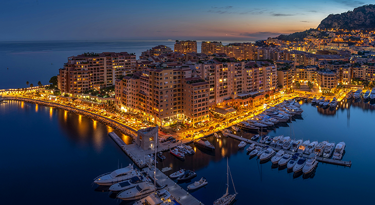 Best time to visit Monaco aerial view of Port Hercule with yachts and Mediterranean sunshine