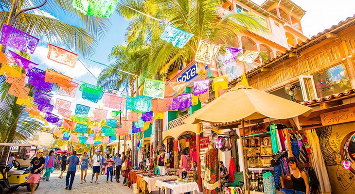 Sayulita beach with palm trees and people