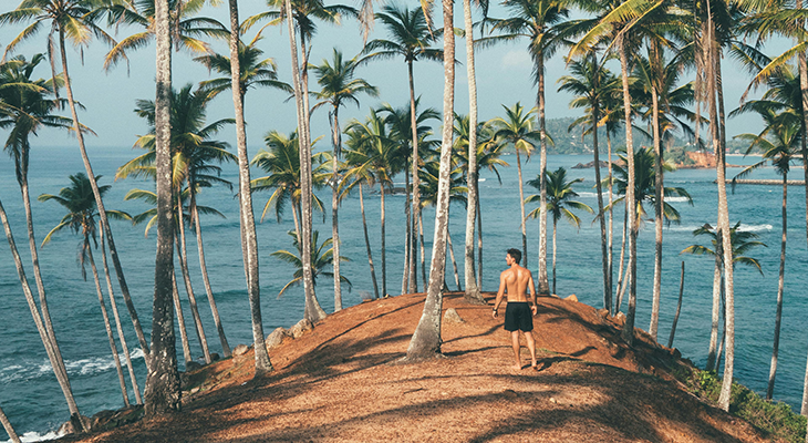 southeast asia traveler standing by a beach
