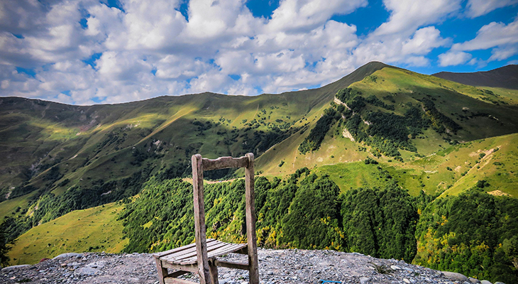 travel to georgia hero image showing caucasus mountains, vineyards and batumi coast